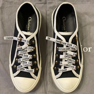 These are Christian Dior black canvas sneakers.